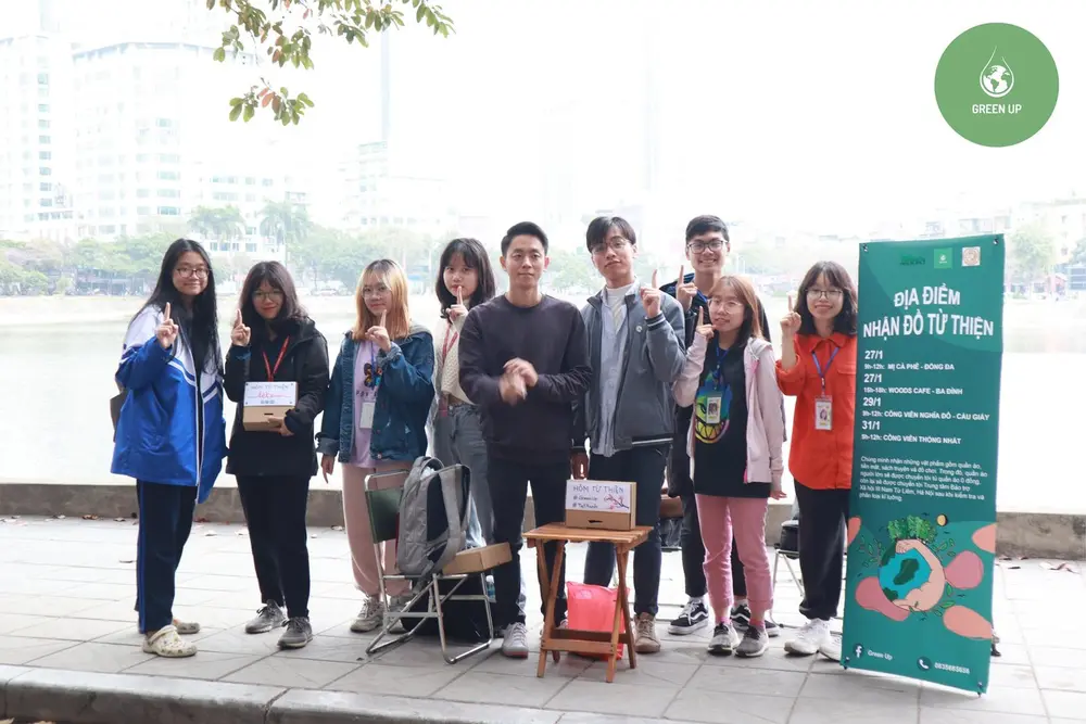 Green Up Youth volunteers at a donation point by a lake in Hà Nội